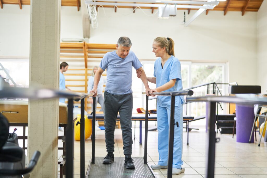 Physical therapist helping patient walk